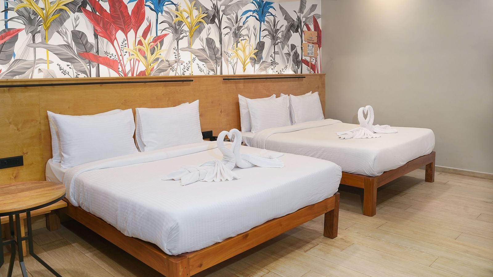 A large bed placed next to another bed in Urban Corner Room at Indie Stays Resort, Goa